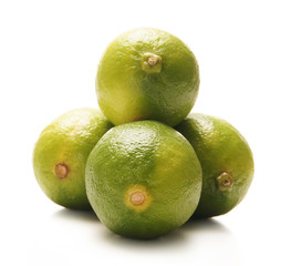 Fresh green limes isolated on a white background