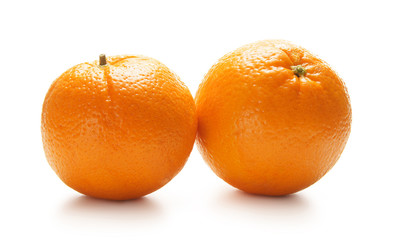 Two fesh and tasty oranges on a white background