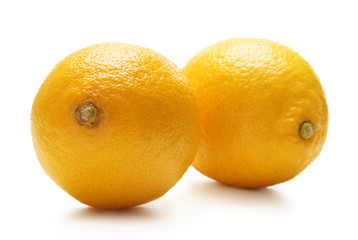 Two fesh and tasty lemons on a white background