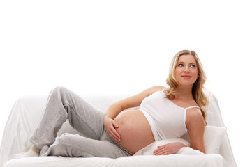 Obraz premium A young and happy pregnant blond Caucasian woman
