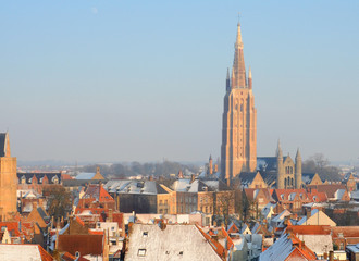 Fototapeta premium Church of Our Lady and roofs in winter in Bruges