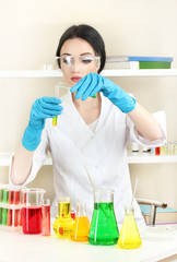 Young female scientist looking in chemistry laboratory