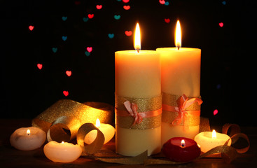 Beautiful candle and decor on wooden table on bright background