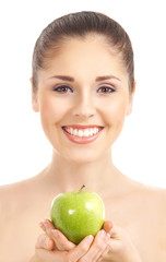 A young and happy woman holding an apple