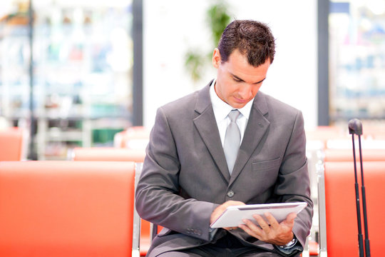 handsome businessman using tablet at airport
