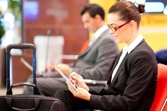 young businesswoman using tablet computer at airport
