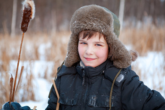 Portrait of  boy wearing  hat, sedge, winter
