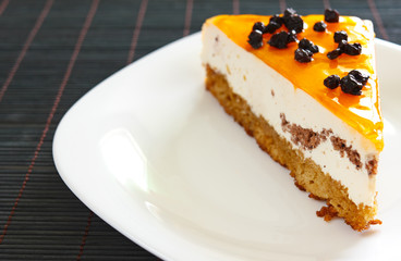 Orange jelly cake with mousse and cranberries on top