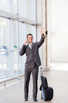 Young Businessman Waving Good Bye At Airport