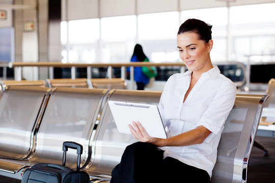 young attractive businesswoman using tablet computer at airport