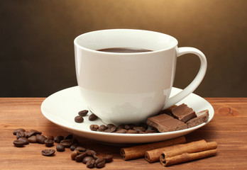 cup of coffee and beans, cinnamon sticks and chocolate