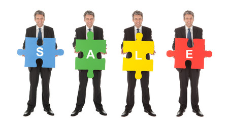 Group of business people holding jigsaw puzzle