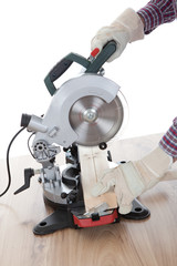 Worker cutting timber using circular saw