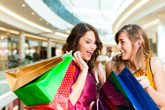 Zwei Freundinnen beim Shoppen in einer Mall