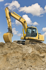 Caterpillar excavator on sand hill