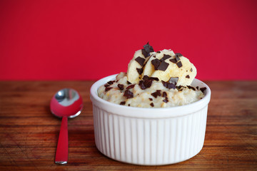 Porridge with sliced banana and chocolate flakes for breakfast