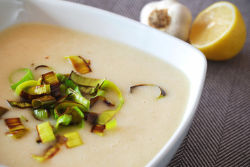 Creamy potato soup with fried leek and lemon, detail
