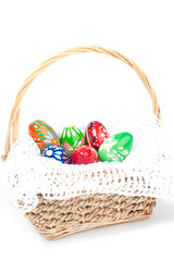Six colored eggs in basket