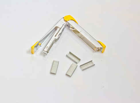 yellow stapler and staples stack  isolated