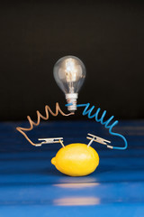 lemon and lamp on black background