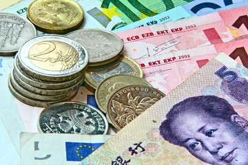 Different currency and coins as a background