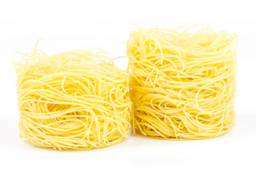 A portion of tagliatelle italian pasta isolated on white