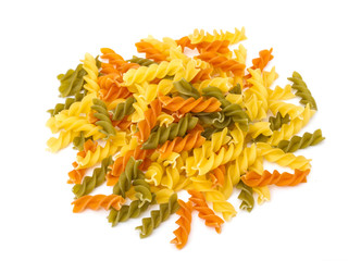 Uncooked pasta fusilli in different colours, white background