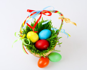 Fototapeta na wymiar Easter eggs in basket with green grass