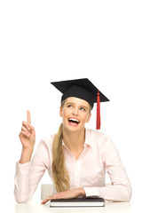 Female graduate pointing up