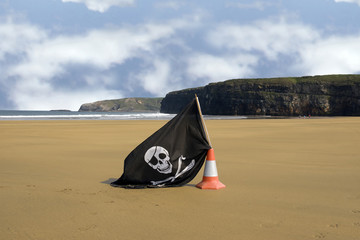 sandy beach with jolly roger flag