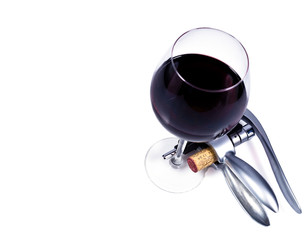 wine glass with red wine and bottlescrew