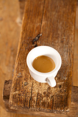 Obraz premium espresso coffee in thick white cup on old wooden bench
