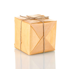 Small parcel wrapped in brown paper tied with twine isolated