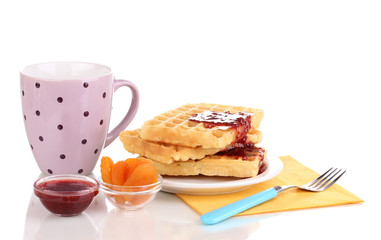 Tasty waffles with jam on plate isolated on white