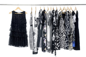 A row of designer fashion clothing hanging on hangers