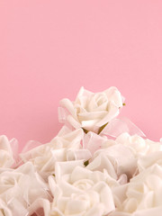 White roses on a pink background