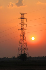 High voltage pole tower and sunset