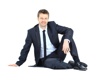Portrait of business man sitting on the floor isolated
