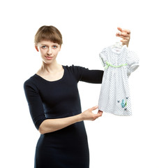 Young mother choosing dress for daughter