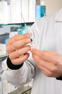 pharmacist holding injection
