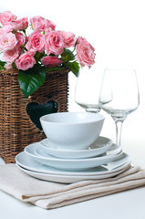 dishes, towels and a basket of flowers