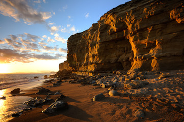 Golden sandstone cliffs at hive beach near Bridport Dorset.