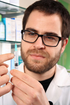 pharmacist holding an injection