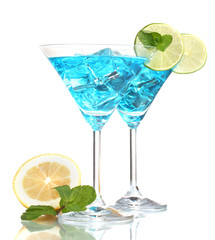 Blue cocktail in martini glasses with ice isolated on white