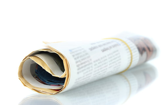 Roll of newspaper isolated on white.