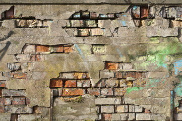 old wall with cracks and graffiti