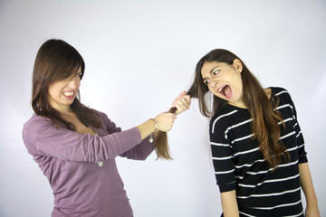 girl pulling the hair of her friend