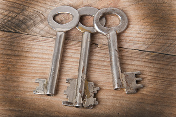 the old keys on a wooden background