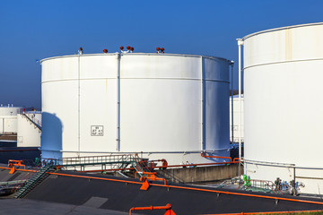white tank in tank farm with blue sky