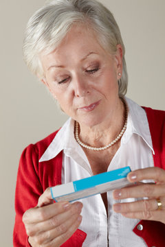 Senior Woman Looking At Prescription Drug Pack